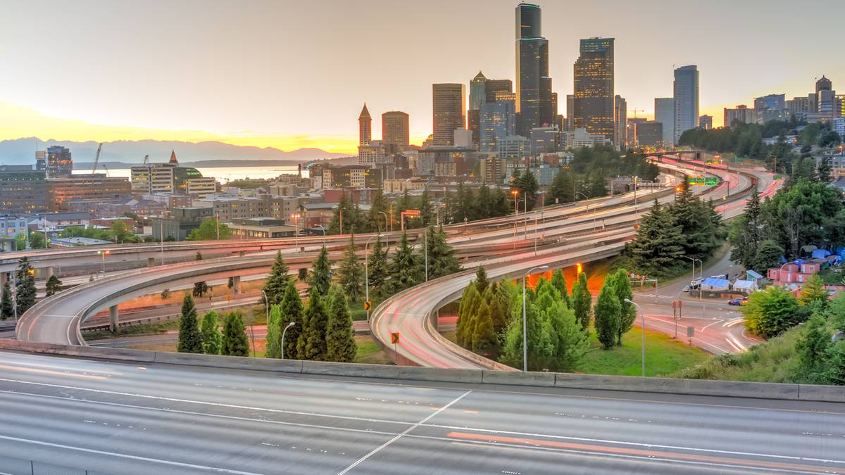 Widok na autostrady i panoramę miasta Seattle o zachodzie słońca.