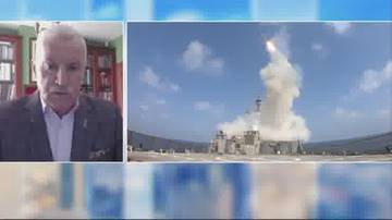 Dwudzielny ekran. Po lewej stronie widać mężczyznę w garniturze, po prawej kadr z odpaleniem rakiety.