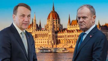 Dwaj mężczyźni w garniturach, Karol Nawrocki i Donald Tusk, stoją na tle majestatycznego budynku węgierskiego Parlamentu w Budapeszcie.