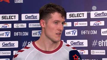 Wiktor Tomczak udzielający wywiadu na tle ścianki sponsorskiej.