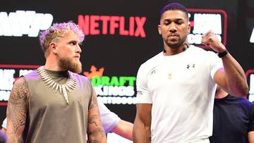Jake Paul i Anthony Joshua stoją naprzeciw siebie.