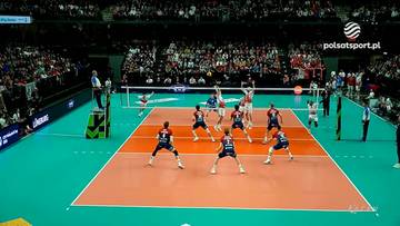 Drużyna siatkarska podczas meczu w hali, gracze w akcji na boisku.