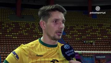 Portret siatkarza Miłosza Zniszczoła w ż&oacute;łtej koszulce z zielonymi akcentami. Jest podczas wywiadu, a w tle widać trybuny wypełnione widzami.