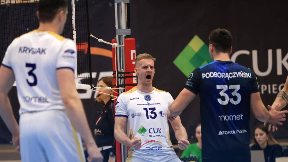 Trzech siatkarzy na boisku podczas meczu siatk&oacute;wki, jeden z nich świętuje zdobyty punkt.