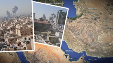 Widok na miasto z unoszącym się dymem nad budynkami, wskazujący na eksplozje.