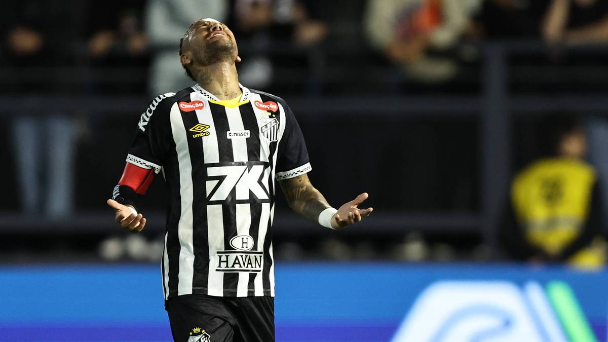 Piłkarz Neymar w czarno-białej koszulce z numerem 7K i logiem "HAAN" na piersi, z rękami rozłożonymi na boki i zadartą głową, podczas meczu piłkarskiego.