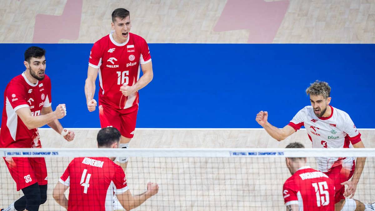 Siatkarze w biało-czerwonych strojach świętują punkt na boisku siatkarskim.