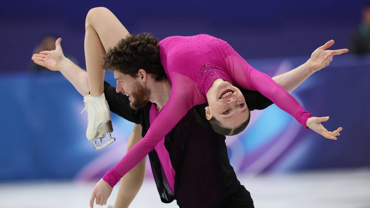 Para łyżwiarzy figurowych wykonująca skomplikowaną figurę podczas zawod&oacute;w.