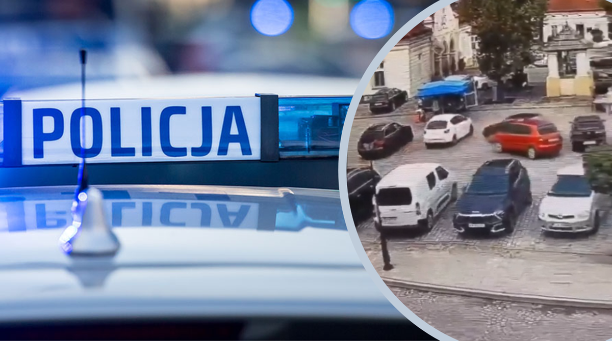 Radiowóz policyjny z niebieskimi kogutami na tle miejskiego parkingu.