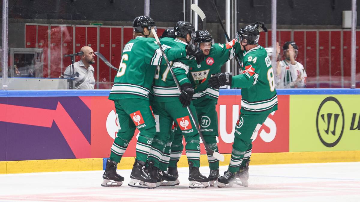 Drużyna hokejowa w zielonych strojach świętuje na lodowisku.