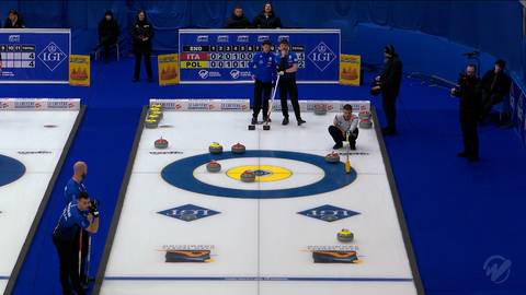 Gracze drużyny Polski i Włoch rywalizują na lodowym torze do curlingu, przesuwając kamienie w kierunku celu.