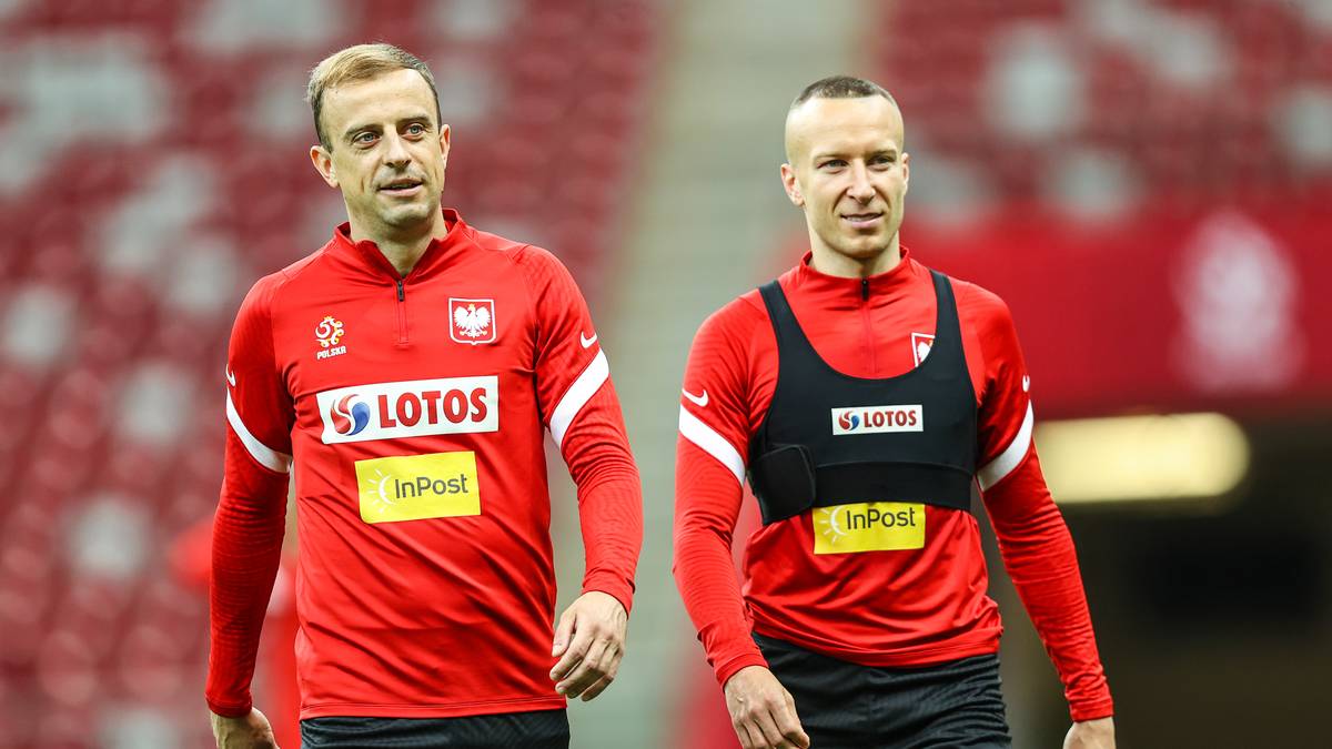 Dw&oacute;ch piłkarzy w czerwonych strojach reprezentacji Polski.