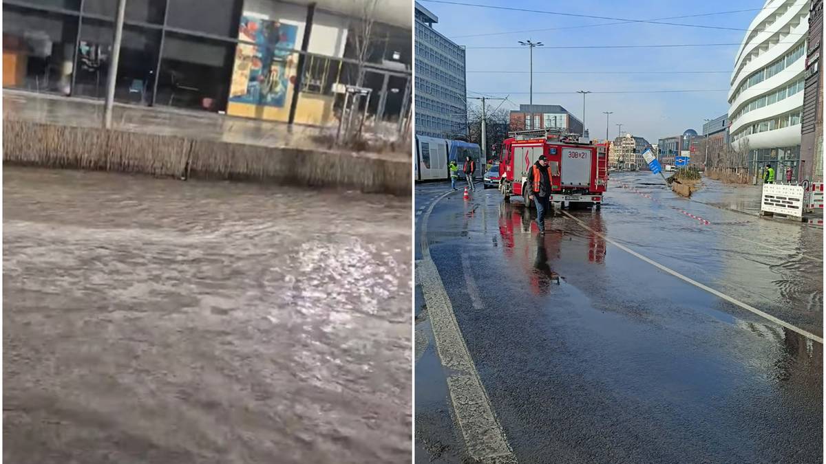 Zalana ulica we Wrocławiu z widocznymi służbami ratowniczymi i wozami strażackimi.