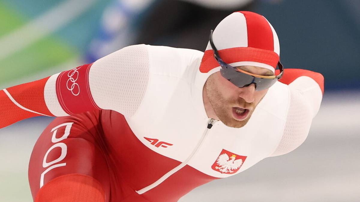 Łyżwiarz szybki w stroju reprezentacji Polski na lodowisku.