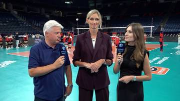 Marek Magiera oraz dwie dziennikarki przeprowadzający wywiad na tle boiska do siatkówki w hali sportowej.