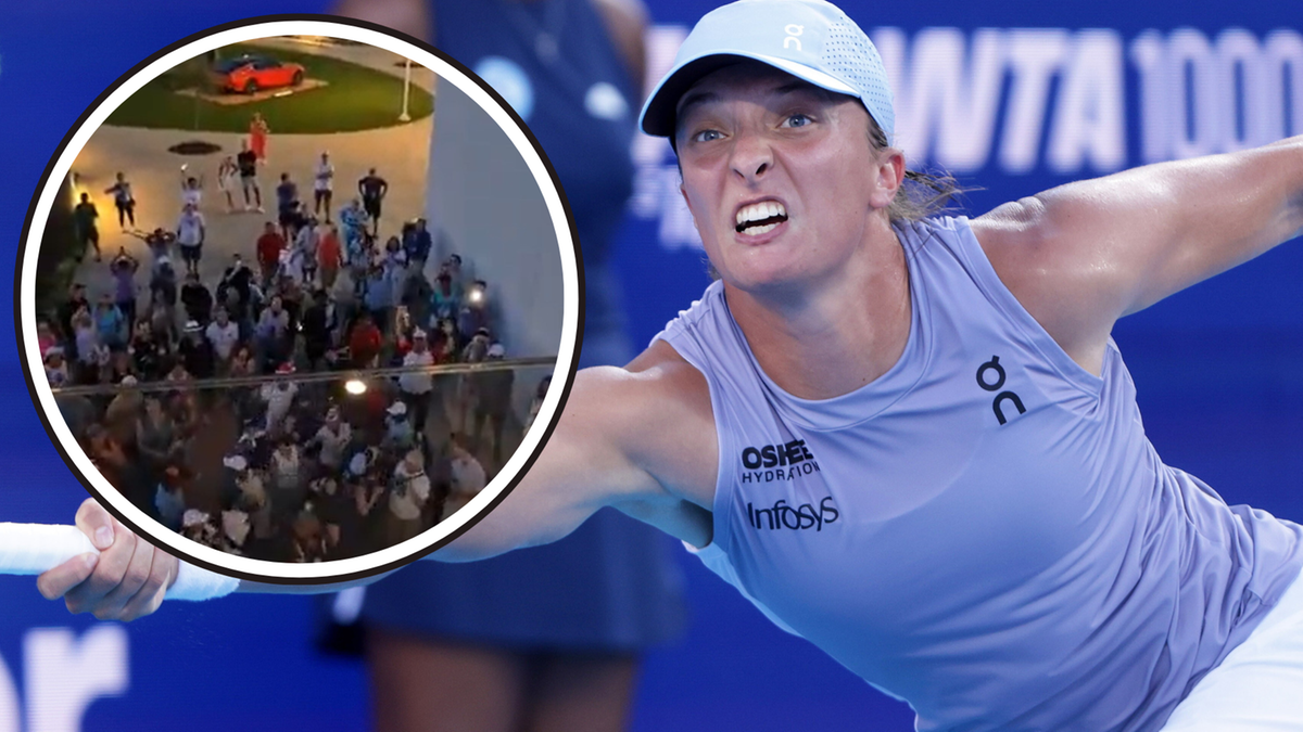 Iga Świątek, tenisistka, w trakcie meczu, zdeterminowana, skupiona na uderzeniu, zaciśnięte usta, w tle tłum kibiców.