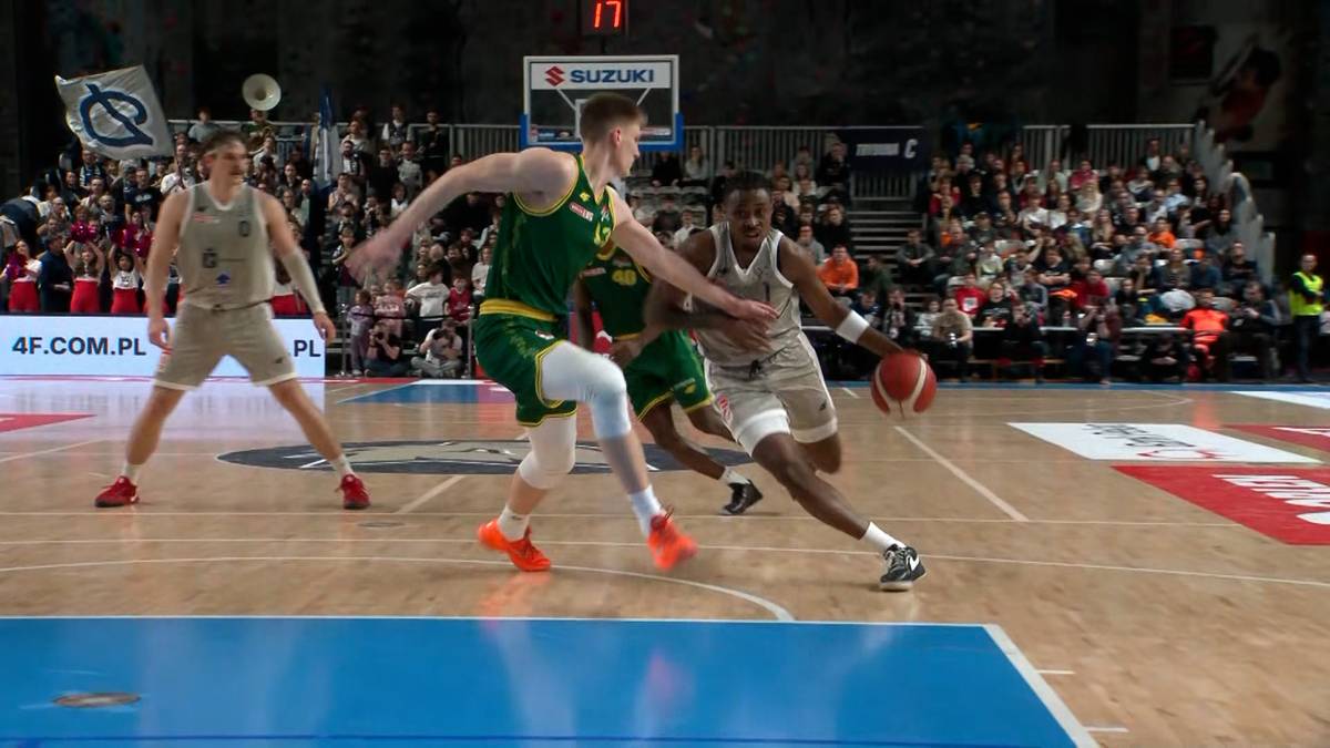 Dw&oacute;ch koszykarzy walczy o piłkę podczas meczu.