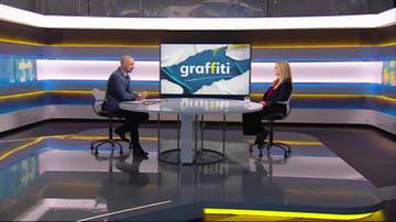 Mężczyzna i kobieta siedzą przy okrągłym stole w studiu telewizyjnym. Na ekranie za nimi wyświetlany jest napis "graffiti".