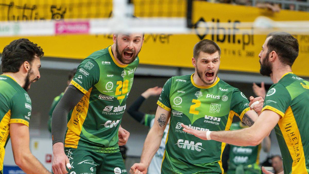Trzech zawodników drużyny siatkarskiej w zielonych strojach, krzyczy i gestykuluje podczas meczu.