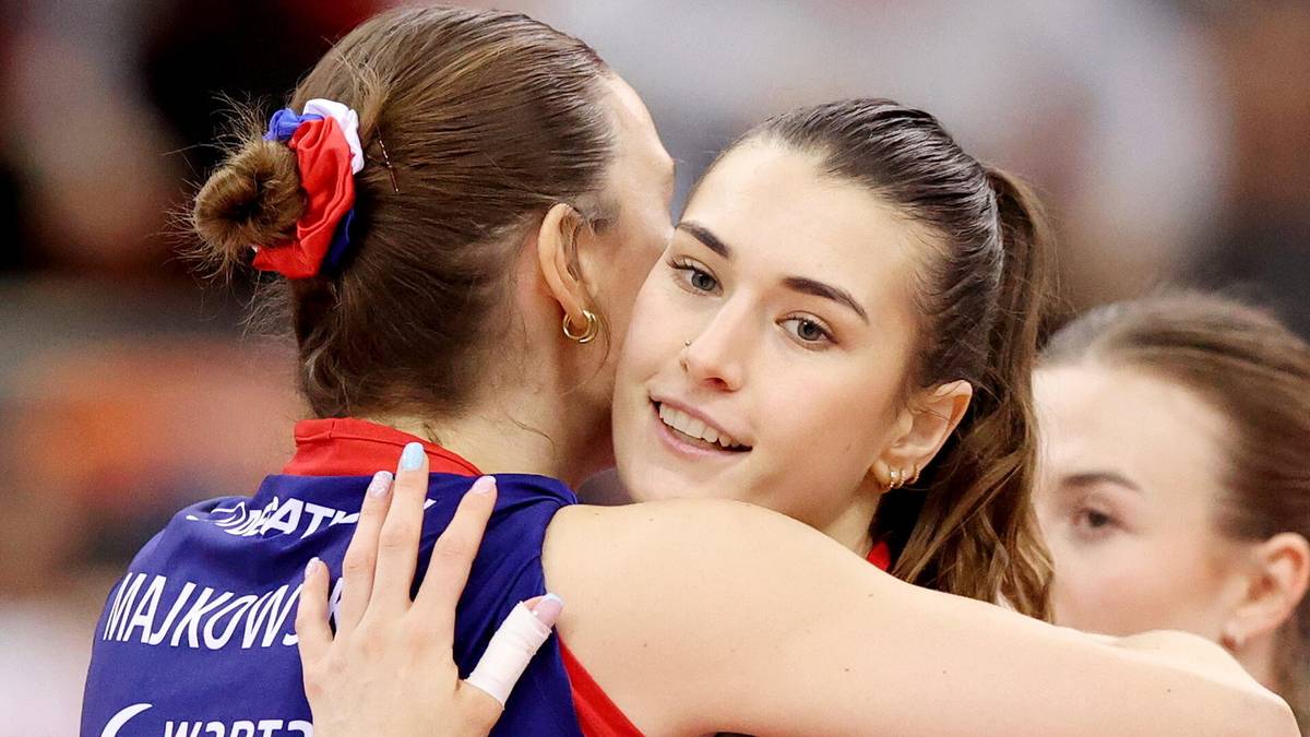 Dwie siatkarki przytulają się po meczu, jedna z nich uśmiecha się do obiektywu.