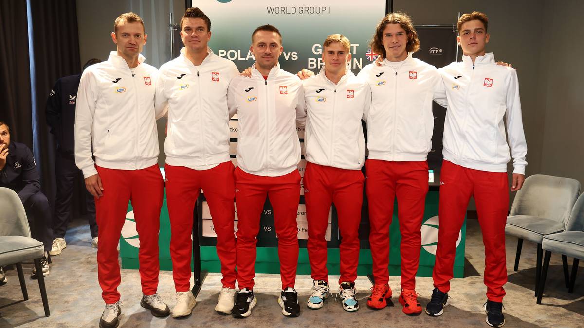 Drużyna tenisowa Polski w strojach sportowych pozuje do zdjęcia.