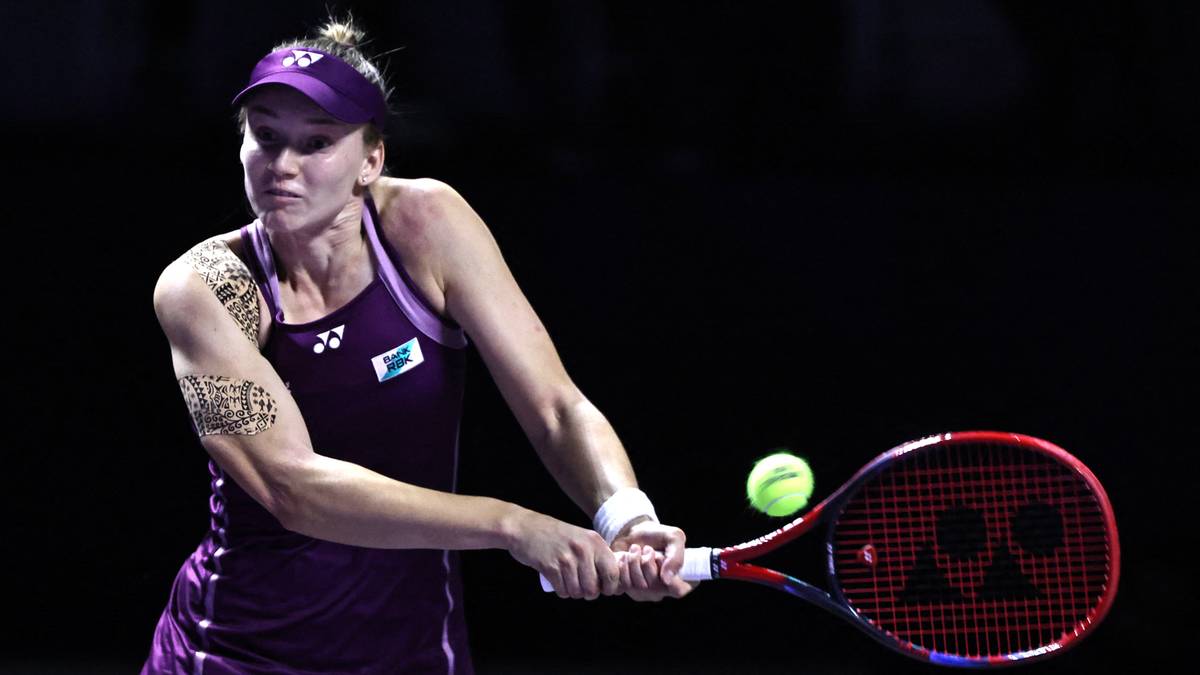 Tenisistka Jelena Rybakina w fioletowym stroju wykonuje uderzenie rakietą tenisową.