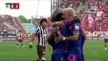 Piłkarze świętują bramkę podczas meczu FC St. Pauli przeciwko 1. FSV Mainz 05. Na ekranie widoczny jest wynik 0:1.