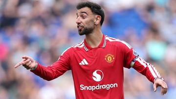 Piłkarz Manchesteru United w czerwonej koszulce, wskazujący palcem.