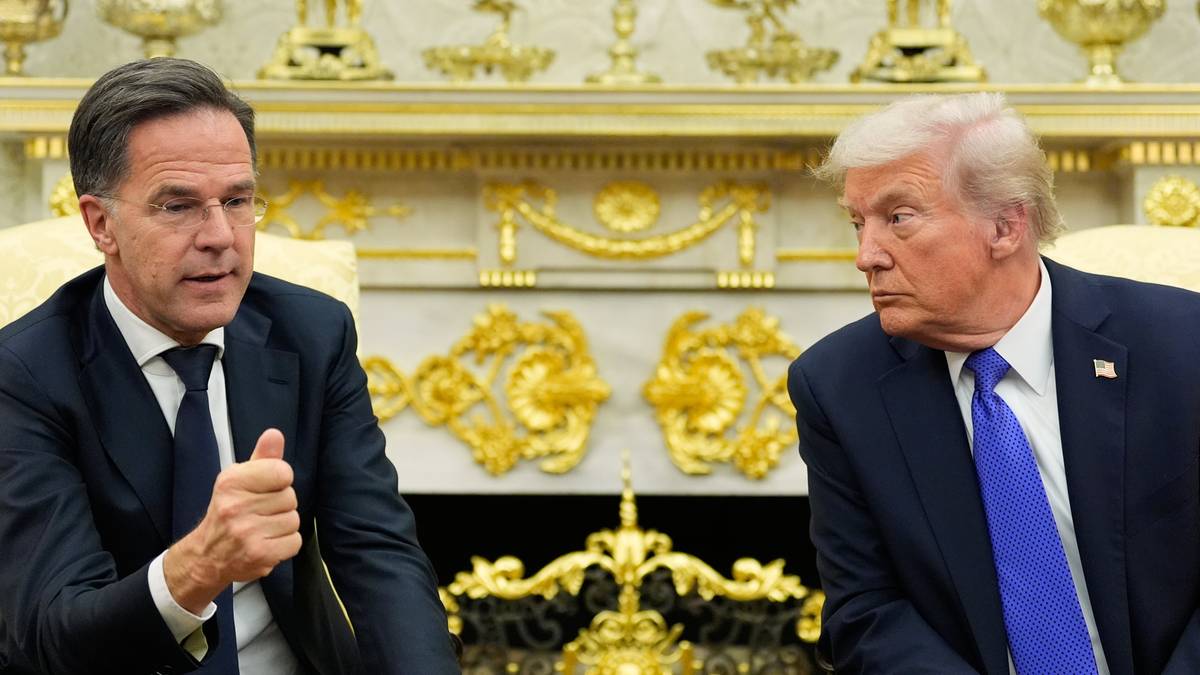 Dwaj mężczyźni w garniturach siedzą naprzeciwko siebie w bogato zdobionym pomieszczeniu.