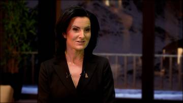 Sylwia Nowak-Trębacka w czarnym żakiecie, uśmiecha się podczas wywiadu.