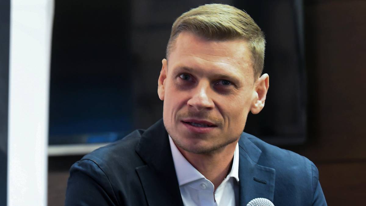 Zbliżenie na twarz mężczyzny w garniturze i białej koszuli.