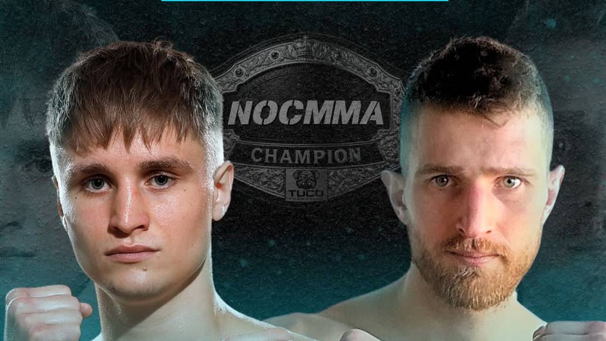 Dwaj mężczyźni w strojach sportowych stoją blisko siebie, patrząc w stronę obiektywu. Na pierwszym planie widoczna jest twarz jednego z nich, z kr&oacute;tkimi jasnymi włosami i poważnym wyrazem twarzy. Drugi mężczyzna, z ciemniejszymi włosami i brodą, znajduje się w tle, jego twarz jest częściowo zasłonięta.