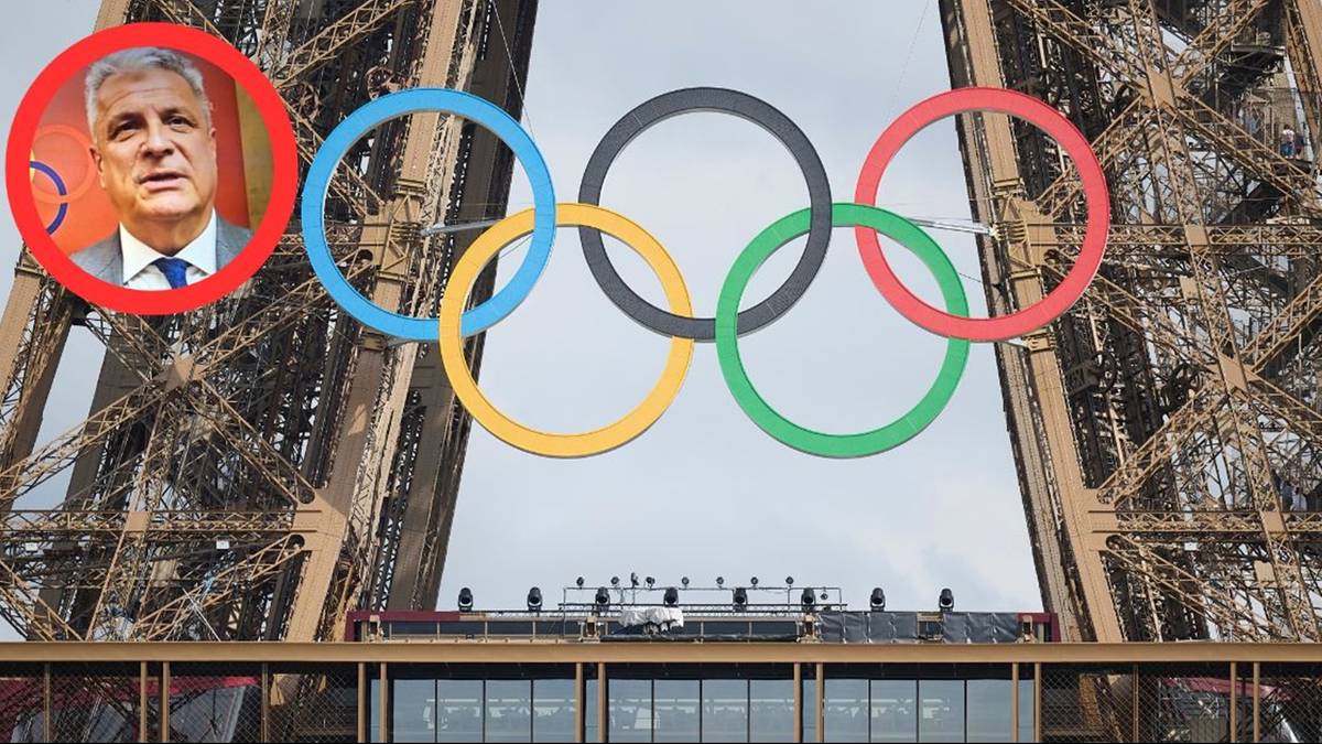 Fragment Wieży Eiffla z nałożonymi kołami olimpijskimi i zdjęciem mężczyzny w lewym górnym rogu.