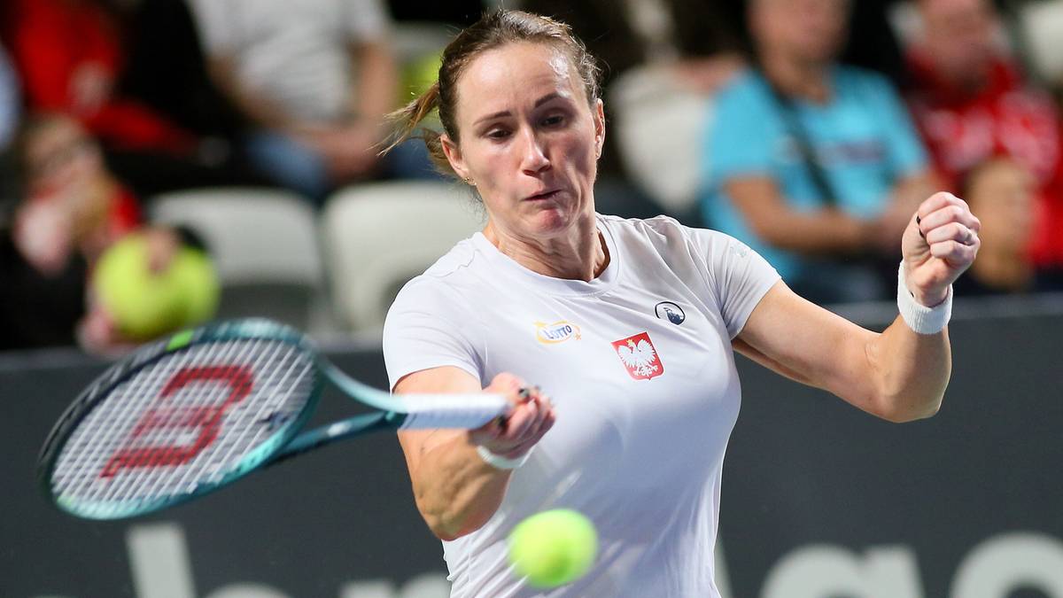 Tenisistka Katarzyna Kawa uderza piłkę rakietą podczas meczu.