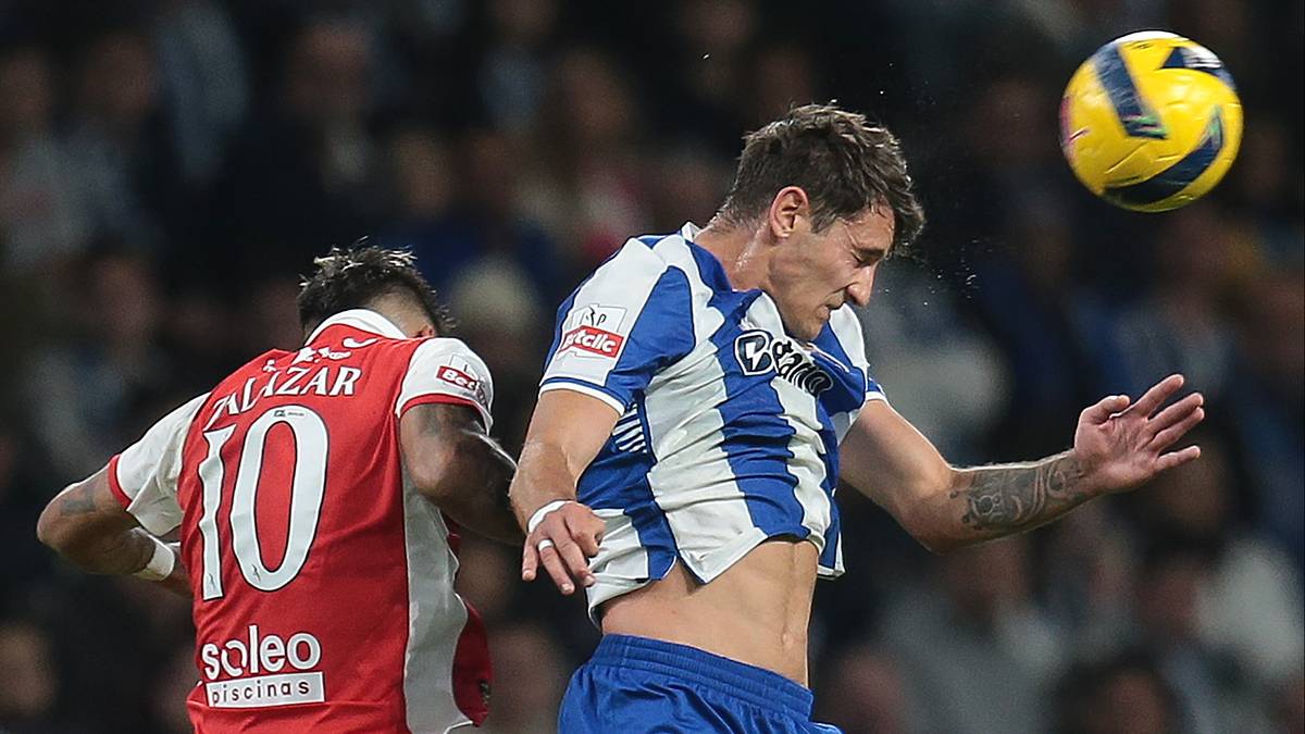 Dwóch piłkarzy grających w piłkę nożną, jeden z nich wyskakuje do zagrania głową.