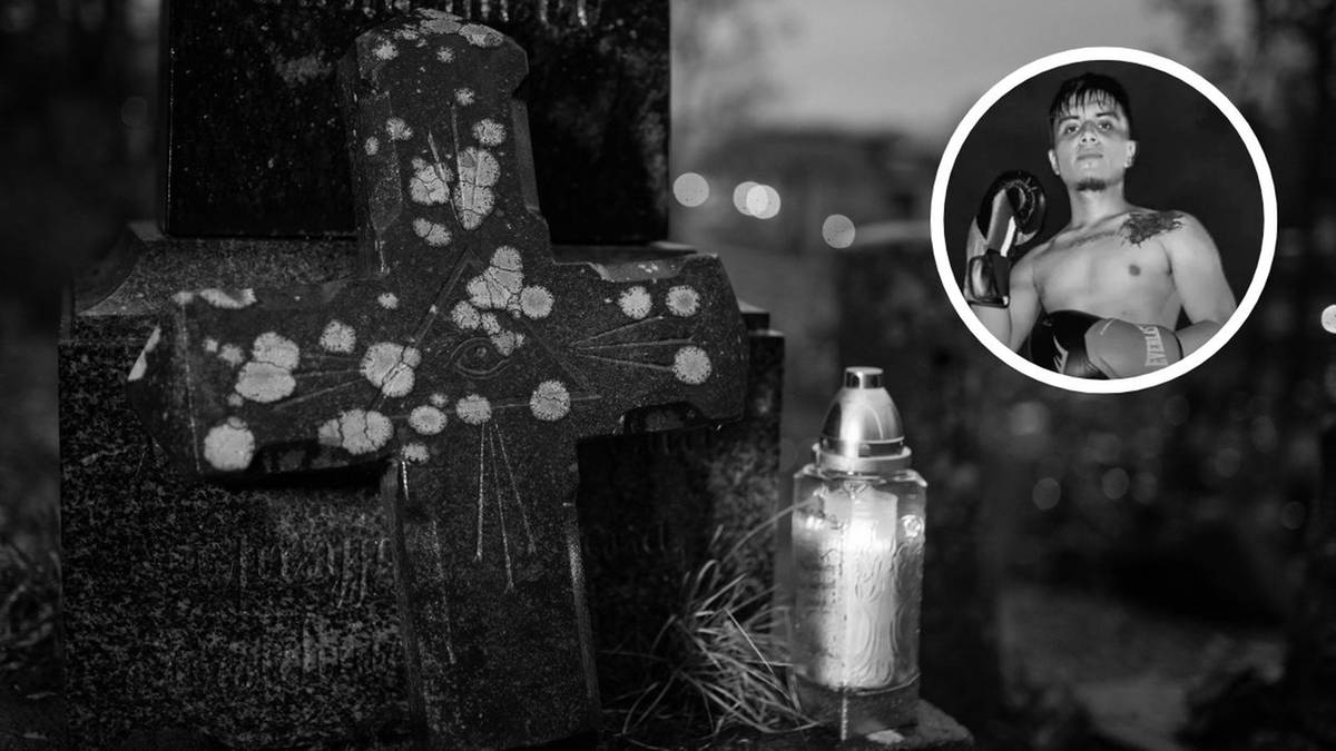 Krzyż nagrobny z płonącą świecą i okrągłe zdjęcie boksera w rękawicach.