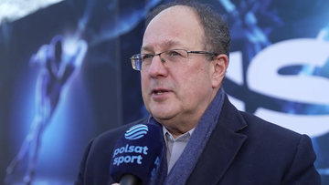 Marian Kmita w okularach i szaliku udziela wywiadu z mikrofonem Polsat Sport.