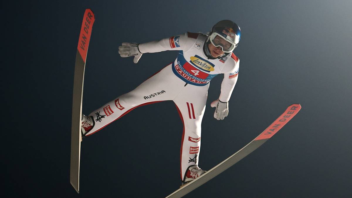 Skoczek narciarski w locie podczas zawodów.