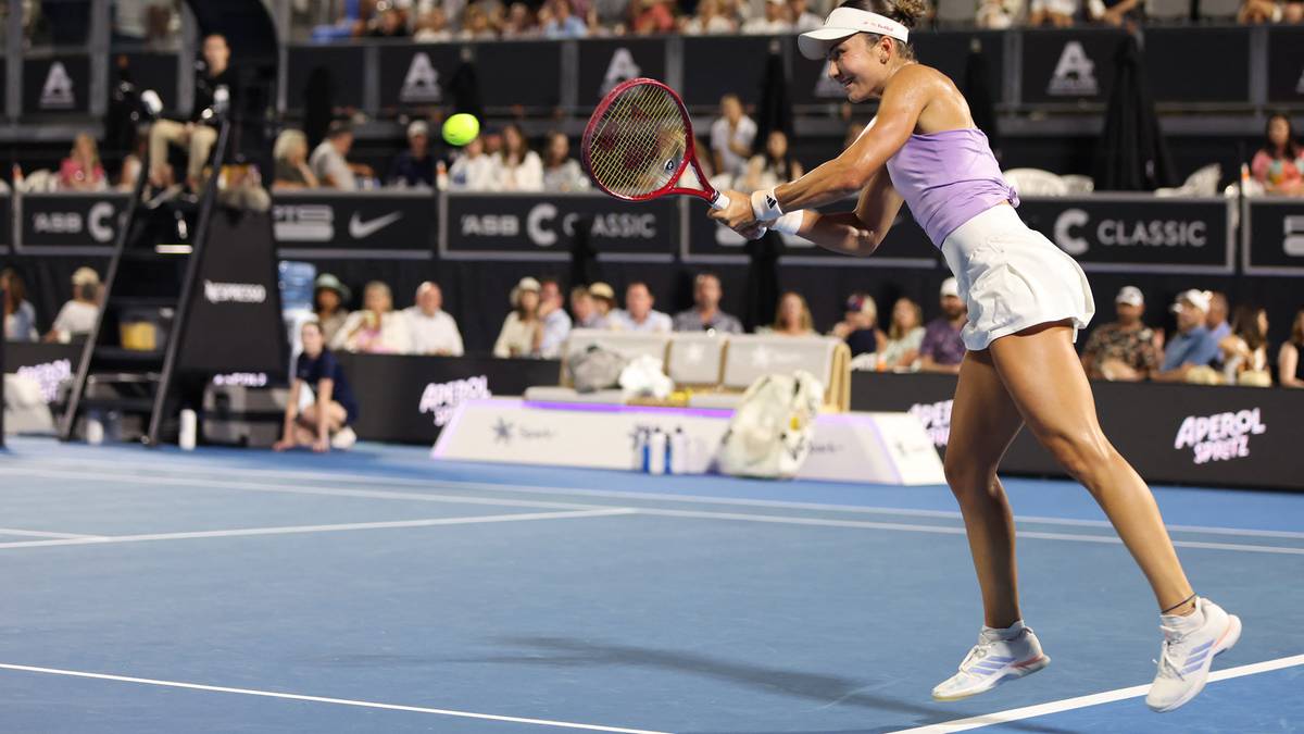 Tenisistka uderzająca piłkę podczas meczu na korcie tenisowym.