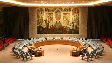 Sala posiedzeń Rady Bezpieczeństwa ONZ z owalnym stołem i krzesłami.