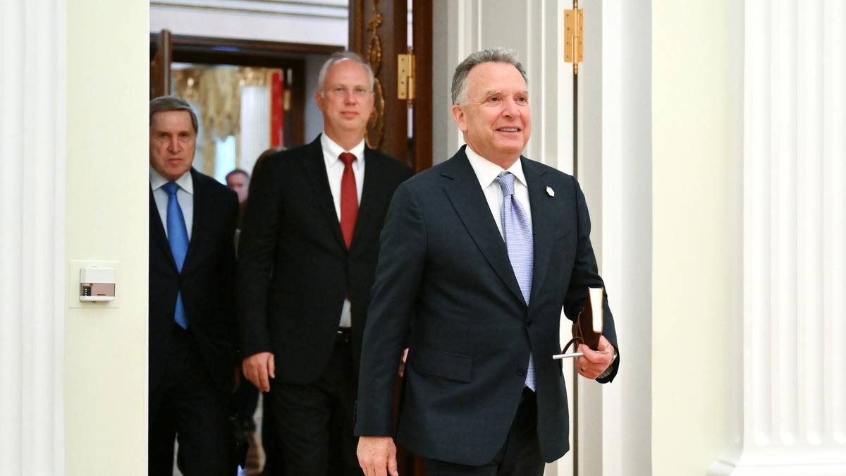 Trzech mężczyzn w garniturach wchodzi do pomieszczenia.