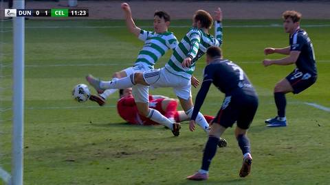 Gracze w zielono-białych strojach walczą o piłkę na boisku piłkarskim z przeciwnikami w granatowych strojach. Na ekranie widoczny jest wynik meczu Dundee 0-1 Celtic.