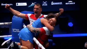 Dw&oacute;ch bokser&oacute;w przytulających się w ringu po zwycięstwie.