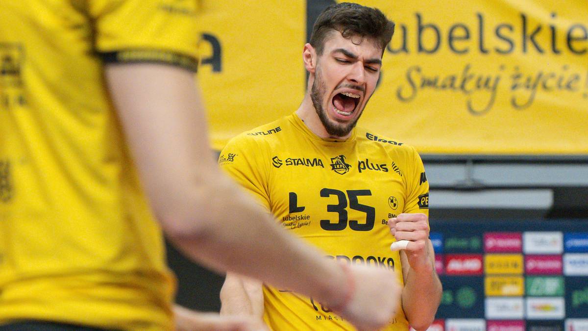 Młody siatkarz w żółtej koszulce z numerem 35 krzyczy z radości lub wysiłku, zaciskając prawą pięść.