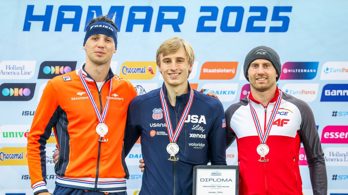 Trzech mężczyzn w strojach sportowych pozuje na podium, każdy z medalem na szyi i dyplomem.