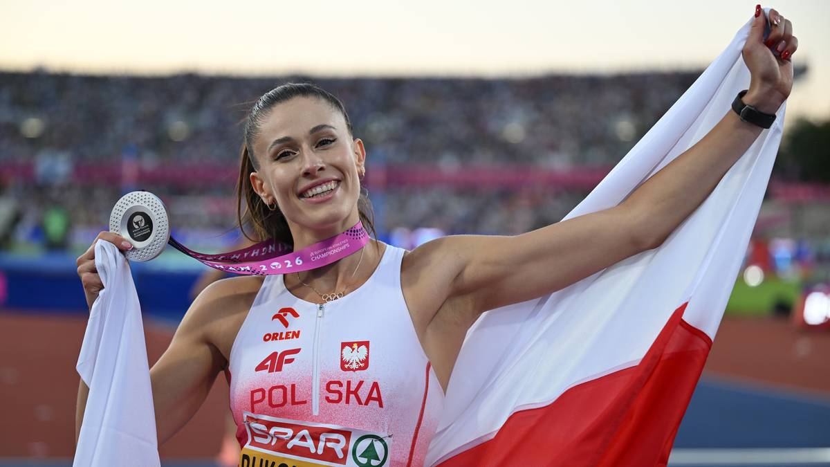 Lekkoatletka Natalia Bukowiecka z polską flagą i medalem na szyi.
