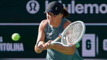 Tenisistka Iga Świątek podczas uderzenia rakietą, skupiona na piłce tenisowej.