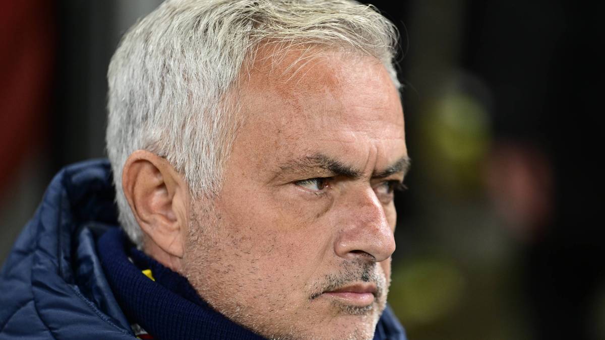 Portret Jose Mourinho, trenera piłkarskiego, patrzącego w bok z zamyślonym wyrazem twarzy.