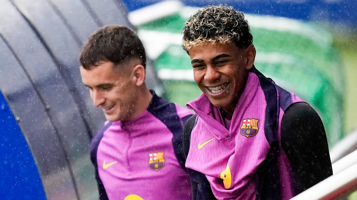 Trzech piłkarzy FC Barcelony w strojach treningowych w kolorach fioletowo-granatowym, wchodzących po schodach.