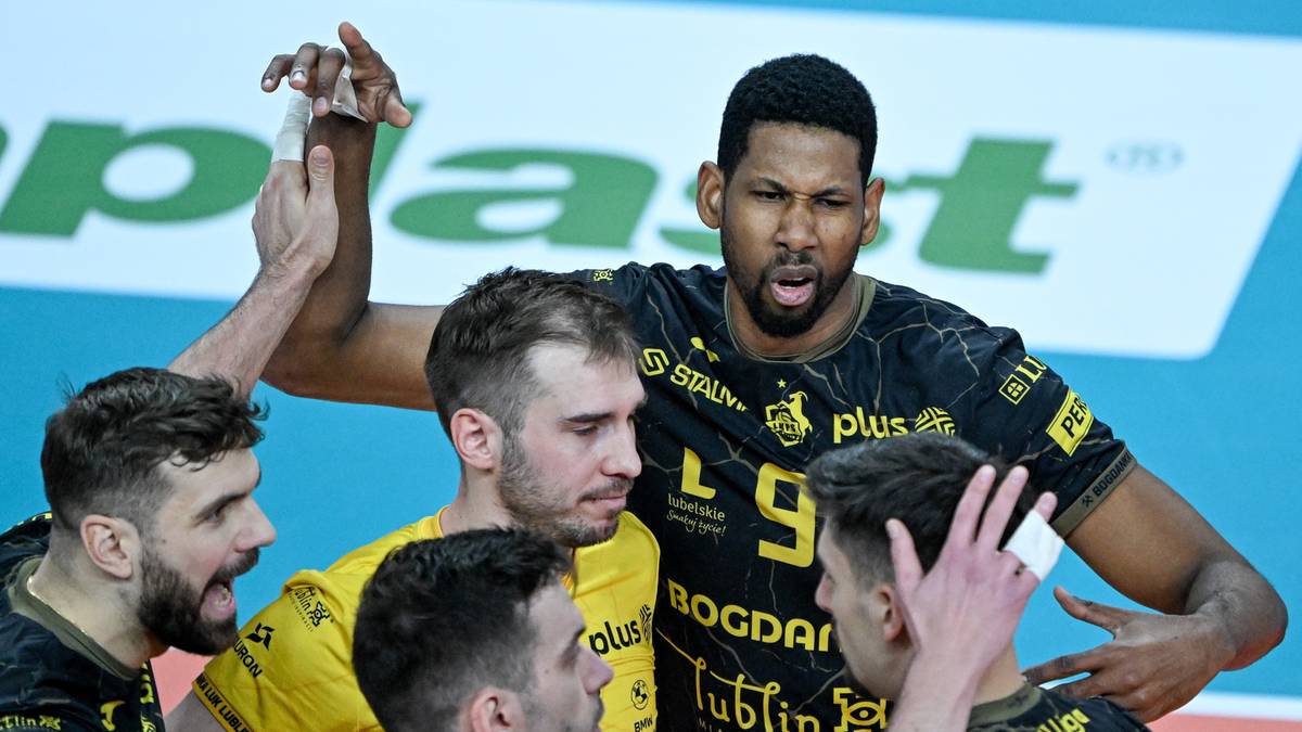 Pięciu siatkarzy w ż&oacute;łto-czarnych strojach rozmawia ze sobą na parkiecie.